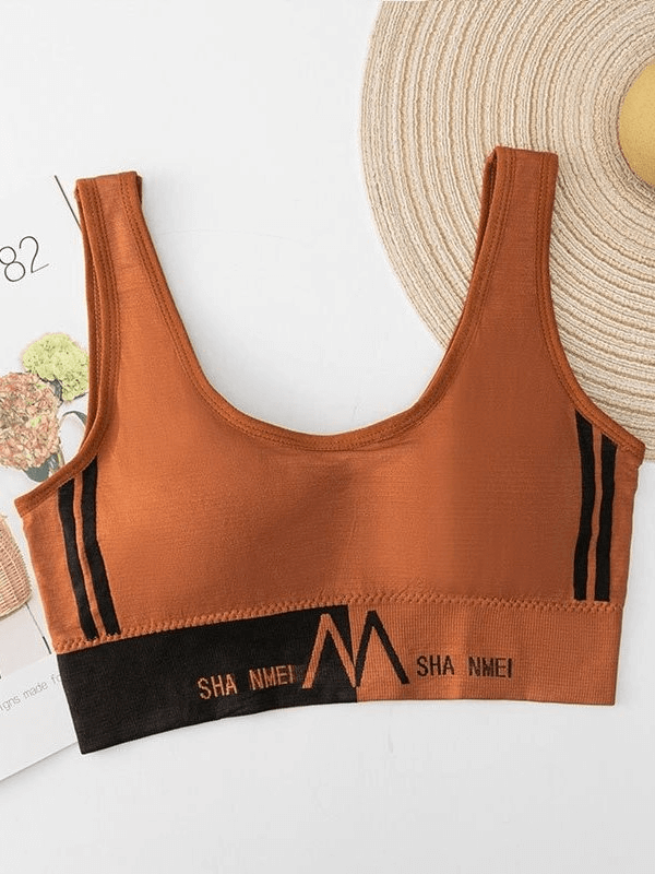 Rust-colored seamless sports bra for women, designed for comfort and performance, featuring anti-friction and quick-dry properties.